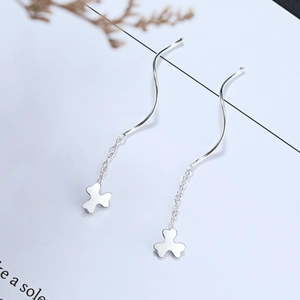 Close-up of S925 sterling silver wavy threader earrings with a clover tassel charm