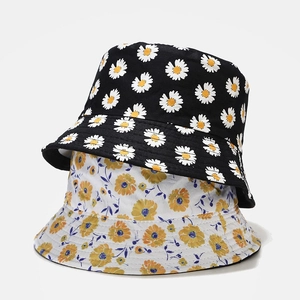 Reversible daisy bucket hats in black floral and yellow-blue print for summer sun protection