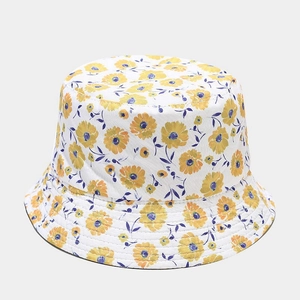 Detail of white cotton bucket hat with yellow daisy floral pattern and stitched brim