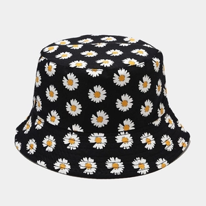 Detail of black cotton bucket hat featuring an all-over white and yellow daisy print