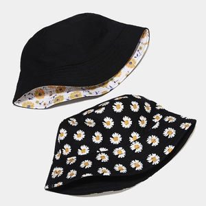 Detail view of cotton bucket hat showing reversible daisy print and solid black design