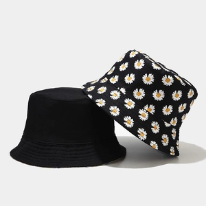 Double-sided sun hat featuring solid black and white daisy pattern on canvas fabric