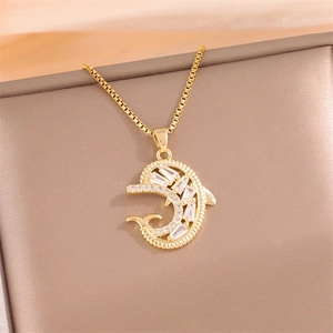 Golden dolphin pendant necklace with zircon crystals on a box chain inside a jewelry box