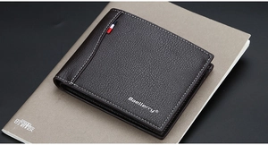 Macro detail of dark brown bifold leather wallet with lychee grain and contrast stitching
