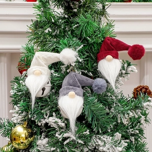 Nordic Christmas gnome hanging ornaments with metal bells and knit hats on a festive tree