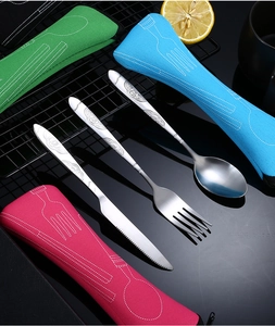 Flat lay of stainless steel cutlery set with colorful portable fabric storage pouches
