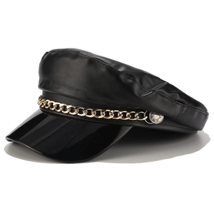 Side view of black faux leather newsboy cap with gold chain and silver side buckle