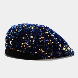 Detail of navy blue sequins and black velvet trim on a stylish sequin beret hat