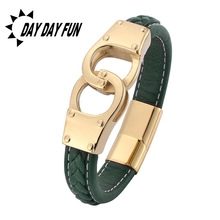 Detailed macro view of dark green braided leather bracelet with golden handcuff clasp