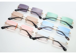 Close-up of frameless rectangle sunglasses with colorful gradient lenses and metal temples