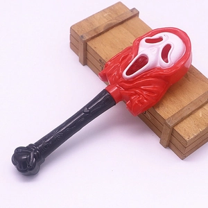 Close-up of Halloween ghost face scepter featuring a red mask and detailed black handle