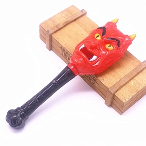 Detail of red glow-in-the-dark devil head magic wand for Halloween party decoration