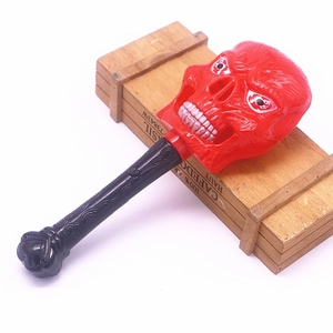 Detail view of a red skull hand hammer with a spiral handle for Halloween parties