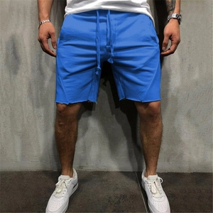 Men's royal blue casual sports shorts with drawstring waist and raw edge hem on model