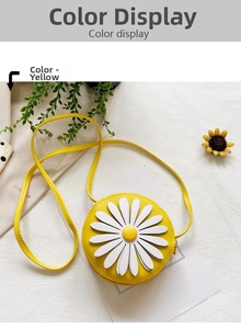 Detail of yellow round crossbody bag with 3D white daisy flower on textured fabric
