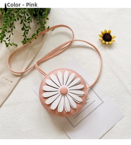 Detailed close-up of a pink children daisy crossbody bag with realistic 3D flower petal