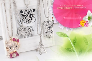 Detail showing various crystal-encrusted charms including kitty and elephant designs