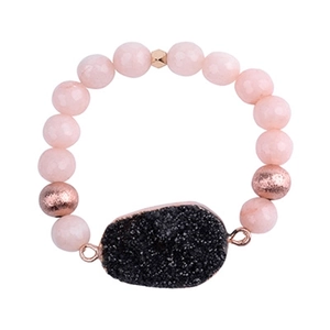 Detail of beaded quartz bracelet with rose gold accents and druzy stone pendant