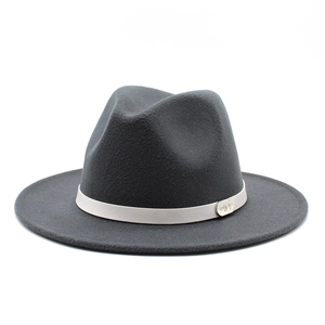 Detail of dark gray wool fedora hat featuring a stylish brim and decorative band with logo