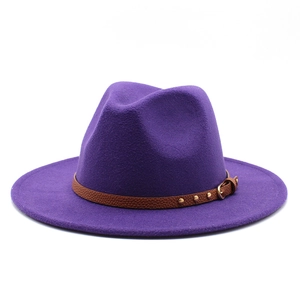 Detail of purple wool fedora hat featuring a brown leather band with gold metal studs