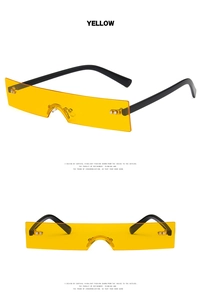 Detail view of yellow rectangle rimless sunglasses with black temples and screw hardware
