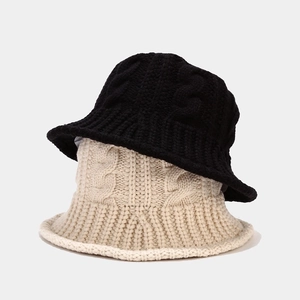Winter chunky knit bucket hat for women with cable pattern in black and beige colors