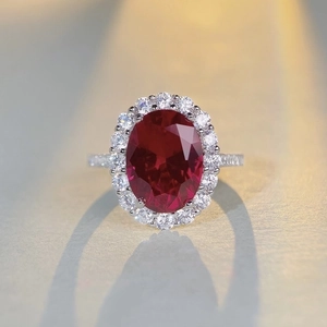 Elegant S925 silver ring featuring a large oval red ruby surrounded by sparkling cubic zirconia