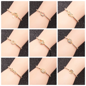 Set of 9 beaded bracelets with colorful rhinestone charms showing tree of life and crown