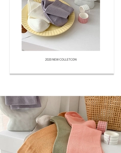 Detail view of colorful ribbed cotton socks in Morandi tones arranged on a tray