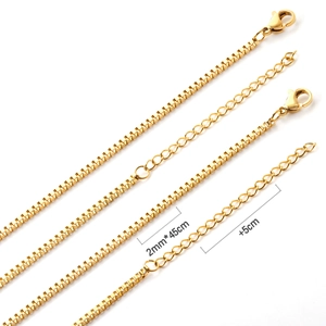 Detail of 2mm gold box chain necklace featuring lobster clasp and 5cm extension link