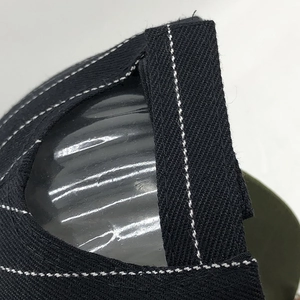Macro view of black twill cotton pinstripe baseball cap with white stitching details