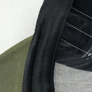 Macro detail of high-quality stitching on olive canvas and black nylon strap of the baseball cap