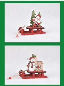 Close-up of DIY wooden Christmas sleigh with Santa Claus and snowman festive figurines