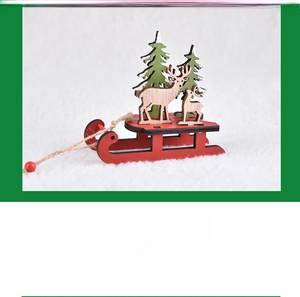 Close-up of wooden Christmas sleigh with green trees and reindeer on snowy base