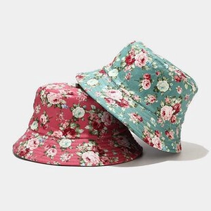 Detail of floral bucket hats with rose patterns and durable cotton canvas material