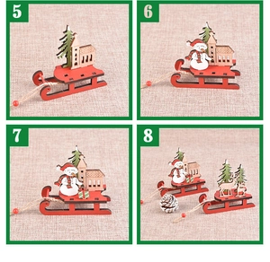 Detail of four colorful wooden Christmas sled ornaments with festive laser-cut designs