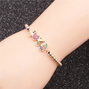 Colorful beaded bracelet with micro-p鑲ed zircon LOVE charm on a black textured background