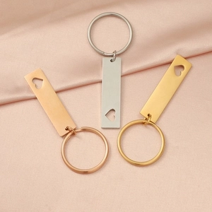 Set of 3 hollow heart tag keychains in gold silver and rose gold on pink silk