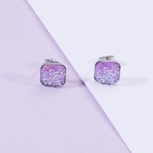 Detailed view of square stud earrings with purple gradient glitter and silver base