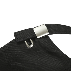 Detail of adjustable metal buckle and black twill cotton strap on baseball cap