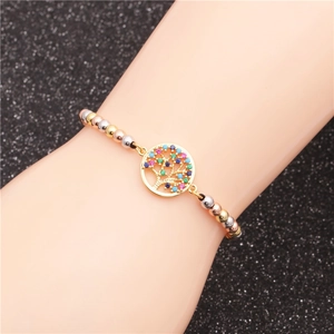 Close-up of tree of life charm bracelet with colorful zircon inlay on model's wrist