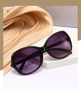 Detail view of purple gradient polarized lenses on black oval frame sunglasses