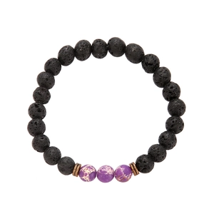 Detail of volcanic stone bracelet with purple imperial beads and metallic spacers
