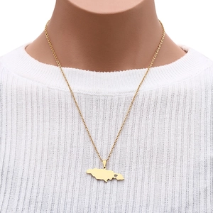 Jamaica map pendant necklace in gold finish worn by a model on a white background