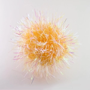 Macro shot of 6cm orange crinkle ball cat toy with iridescent tinsel and laser texture