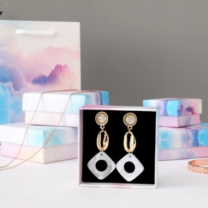 Detail of gradient cloud jewelry box set with earrings and matching gift bag packaging