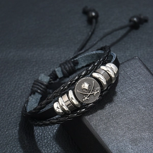 Adjustable multi-layer black leather bracelet with silver skull and crossbones bead detail