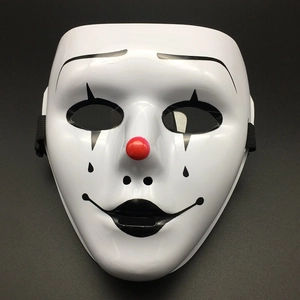 Detailed view of white clown mask with red nose and black painted facial patterns