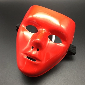 Detailed close-up of a red full-face plastic masquerade mask with elastic strap