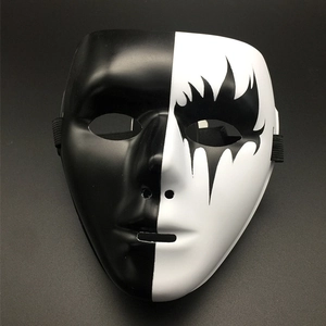 Detail of a black and white split-face hip-hop mask with flame art for dance performance